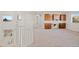 Upstairs bonus room with built-in desk and cabinets, neutral carpeting, and large window at 1936 Alpine Dr, Erie, CO 80516