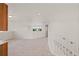 Upstairs bonus room featuring stairs, neutral carpeting, and large window at 1936 Alpine Dr, Erie, CO 80516