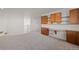 Upstairs bonus room featuring built-in desk and cabinets with neutral carpet at 1936 Alpine Dr, Erie, CO 80516