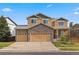 Charming two-story home with a stone facade and three-car garage at 1936 Alpine Dr, Erie, CO 80516