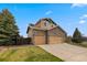 Spacious home with a three-car garage, stone accents, and well-maintained lawn at 1936 Alpine Dr, Erie, CO 80516