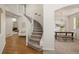 Grand foyer with hardwood floors, a curved staircase, and elegant lighting at 1936 Alpine Dr, Erie, CO 80516