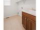 Functional laundry room with utility sink, cabinet storage, and tiled flooring at 1936 Alpine Dr, Erie, CO 80516