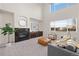 Cozy living room with high ceilings, fireplace, and large windows offering natural light at 1936 Alpine Dr, Erie, CO 80516