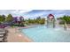 Bright community pool with water features, a slide, lounge chairs, and a lifeguard stand on a sunny day at 1936 Alpine Dr, Erie, CO 80516