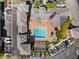 Aerial view of a community pool with surrounding buildings, parking lots, and a recreation area at 3865 S Dayton St # 105, Aurora, CO 80014