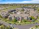 Stunning aerial view of a condo community with lush landscaping, pool, and city skyline in the background at 3865 S Dayton St # 105, Aurora, CO 80014