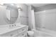 Clean bathroom with a modern vanity, round mirror, and a shower-tub combination with white tiles at 3865 S Dayton St # 105, Aurora, CO 80014