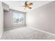 Bright bedroom with carpet flooring, large window, and neutral walls at 3865 S Dayton St # 105, Aurora, CO 80014