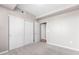 Bedroom with plush carpet, a closet featuring sliding doors and easy access to other rooms at 3865 S Dayton St # 105, Aurora, CO 80014