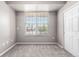 Cozy bedroom featuring plush gray carpeting, neutral walls, and a bright window at 3865 S Dayton St # 105, Aurora, CO 80014