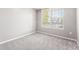 Bright bedroom featuring neutral walls, plush carpet, and a window offering natural light at 3865 S Dayton St # 105, Aurora, CO 80014