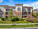 Charming condo building with well-manicured lawn, mature trees, and inviting curb appeal at 3865 S Dayton St # 105, Aurora, CO 80014