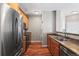 Well-equipped kitchen boasting stainless steel appliances, wood cabinetry, and laundry, enhancing convenience at 3865 S Dayton St # 105, Aurora, CO 80014