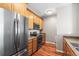 Well-equipped kitchen with stainless steel appliances, wood cabinets, and ample counter space at 3865 S Dayton St # 105, Aurora, CO 80014