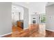 Open-concept living space with hardwood floors, connecting kitchen, living room with fireplace, and balcony at 3865 S Dayton St # 105, Aurora, CO 80014