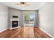 Inviting living room featuring a fireplace, modern ceiling fan, and sliding glass doors at 3865 S Dayton St # 105, Aurora, CO 80014