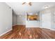 Open-concept living room with wood floors seamlessly flows into the kitchen, perfect for entertaining at 3865 S Dayton St # 105, Aurora, CO 80014