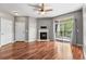 Bright living room featuring hardwood floors, a cozy fireplace, and sliding glass doors to a balcony at 3865 S Dayton St # 105, Aurora, CO 80014