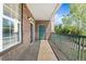 Patio with brick detail, metal railing, and outdoor view of community trees and other features at 3865 S Dayton St # 105, Aurora, CO 80014