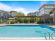 Swimming pool with pergola-covered hot tub, surrounded by well-maintained community buildings at 3865 S Dayton St # 105, Aurora, CO 80014