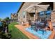 Cozy backyard patio with an umbrella-covered table and manicured artificial lawn at 2012 Sagerock Dr, Castle Pines, CO 80108