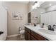 Bathroom featuring double sinks, dark wood cabinets, and neutral-toned walls at 2012 Sagerock Dr, Castle Pines, CO 80108