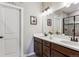 Elegant bathroom with dual sinks, stylish vanity, and a glass-enclosed shower at 2012 Sagerock Dr, Castle Pines, CO 80108