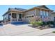 Charming home showcasing a stone and siding exterior with a covered front porch and attached two-car garage at 2012 Sagerock Dr, Castle Pines, CO 80108