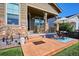 Charming front porch with stone accents and outdoor seating area at 2012 Sagerock Dr, Castle Pines, CO 80108
