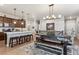 Bright kitchen with a center island and bar stool seating, and modern stainless steel appliances with pendant lighting at 2012 Sagerock Dr, Castle Pines, CO 80108