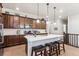 Bright kitchen with a center island, bar stool seating, and ample counter space and cabinetry for cooking at 2012 Sagerock Dr, Castle Pines, CO 80108