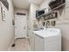 Functional laundry room with modern washer and dryer, storage shelves and convenient access to the home at 2012 Sagerock Dr, Castle Pines, CO 80108