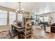 Open-concept living room and dining area featuring a cozy fireplace and comfortable seating, perfect for relaxation at 2012 Sagerock Dr, Castle Pines, CO 80108