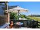 Inviting patio area with umbrella-covered table, perfect for outdoor dining and enjoying the serene surroundings at 2012 Sagerock Dr, Castle Pines, CO 80108