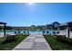 Resort-style community pool with lounge chairs, tables, and beautiful landscaping for relaxation and enjoyment at 2012 Sagerock Dr, Castle Pines, CO 80108