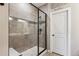 Contemporary walk-in shower with glass enclosure and neutral tile at 2012 Sagerock Dr, Castle Pines, CO 80108