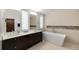 Modern bathroom featuring a double vanity, sleek bathtub, and contemporary fixtures at 3057 S University Cir, Englewood, CO 80113