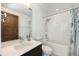 Well-lit bathroom featuring a modern vanity, shower and tub combination, and neutral accents at 3057 S University Cir, Englewood, CO 80113