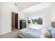 Bright bedroom with a large window offering natural light and a view of the outdoors at 3057 S University Cir, Englewood, CO 80113