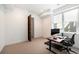 Bedroom features an office space, large window and an attached bath with glass shower at 3057 S University Cir, Englewood, CO 80113