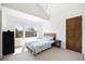 Sunlit bedroom featuring vaulted ceilings and large windows with views of the outdoors at 3057 S University Cir, Englewood, CO 80113