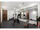 Modern gym is complete with sleek flooring, large mirror, and modern exercise equipment at 3057 S University Cir, Englewood, CO 80113