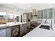 Modern kitchen with a large island, stainless steel appliances, and sleek cabinetry at 3057 S University Cir, Englewood, CO 80113