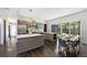 Bright, open kitchen with a large island, stainless steel appliances, and hardwood floors at 3057 S University Cir, Englewood, CO 80113