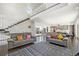 Spacious living room with high ceilings, a staircase, and a view of the backyard at 3057 S University Cir, Englewood, CO 80113