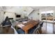 Open-concept living space showcasing the staircase, fireplace, dining area, and outdoor access at 3057 S University Cir, Englewood, CO 80113