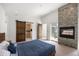 Spacious primary bedroom features a fireplace, ensuite bathroom, and outdoor access at 3057 S University Cir, Englewood, CO 80113