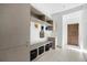 Mudroom with built-in storage, bench seating, and convenient access to the entrance at 3057 S University Cir, Englewood, CO 80113