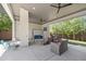 Outdoor patio with seating and ceiling fans provides a relaxing space for entertaining at 3057 S University Cir, Englewood, CO 80113